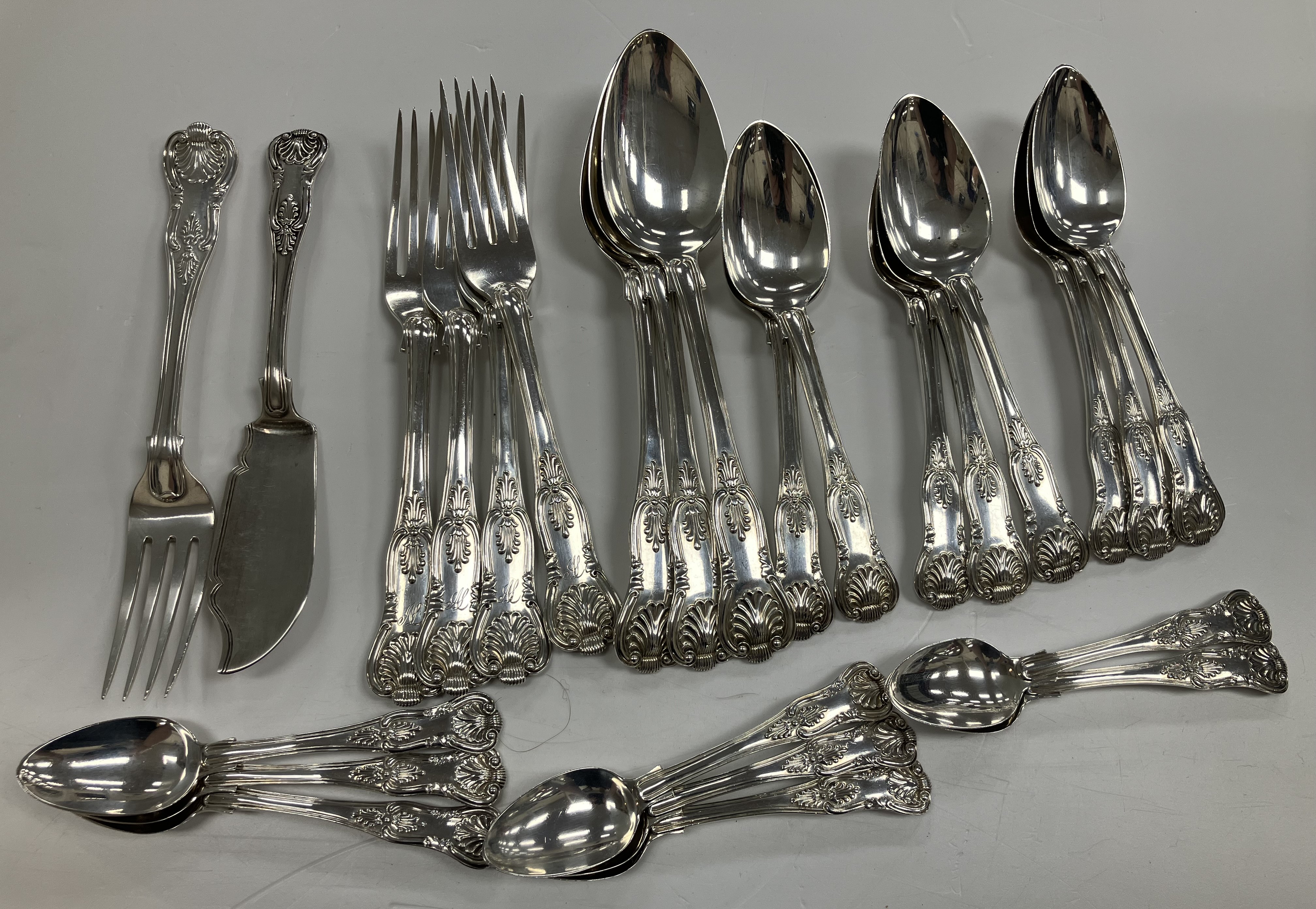 A Victorian King's pattern silver part cutlery canteen comprising eight tea spoons,