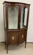 An Edwardian Sheraton Revival mahogany and inlaid serpentine fronted display cabinet,