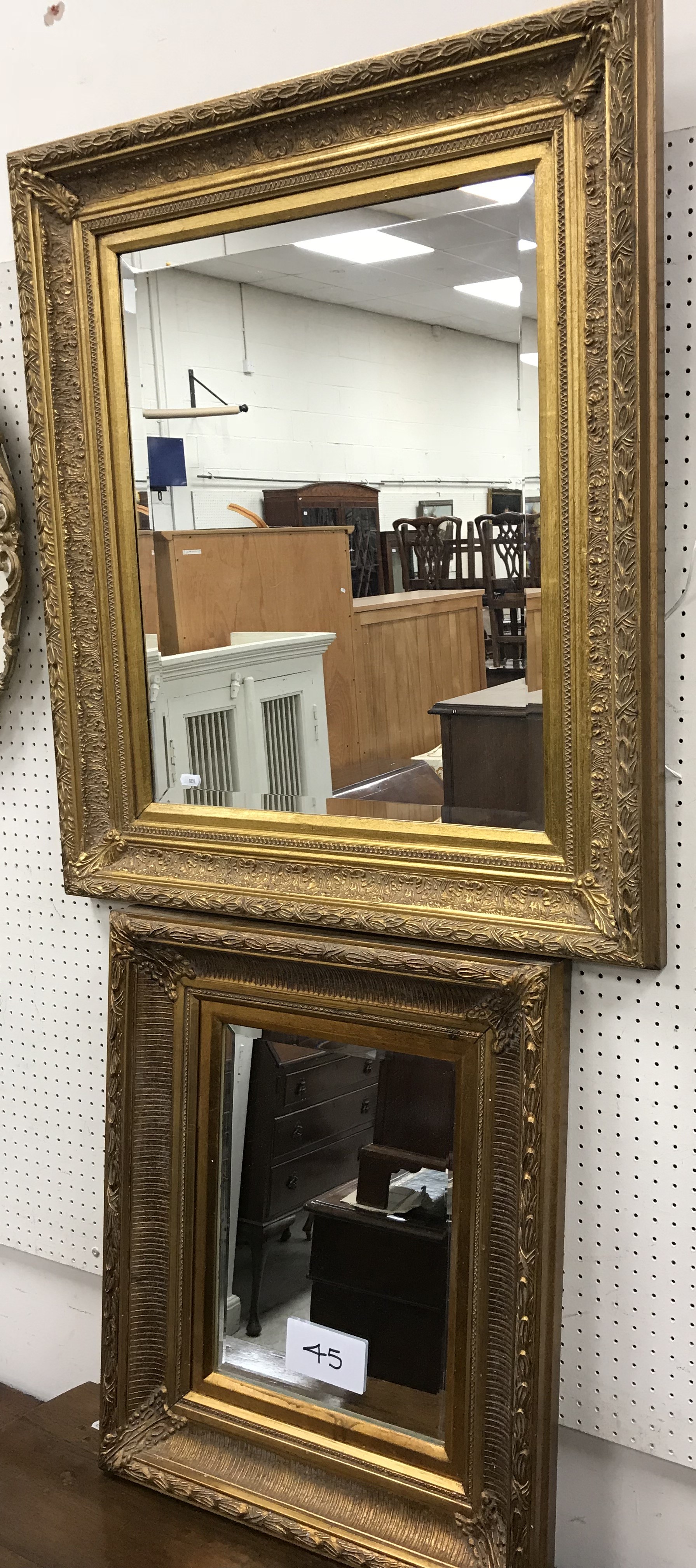 A modern swept gilt framed rectangular wall mirror with bevel edged plate 53 cm x 63 cm together