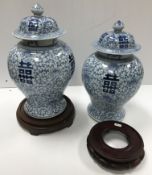 A pair of 20th Century Chinese blue and white marriage vases and covers,