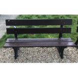 A Bristish Railways bench with wooden slats on cast iron ends 152 cm wide