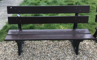 A Bristish Railways bench with wooden slats on cast iron ends 152 cm wide