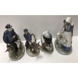 A collection of four Royal Copenhagen figures of farm labourers with cows or goats No'd 779, 772,