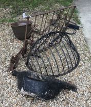 A collection of wrought ironwork to include a hayrack, a gate, a bootscrape,