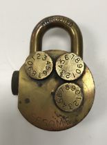 A vintage Sesame quadruple barrel combination lock in brass, 6 cm diameter, 8.