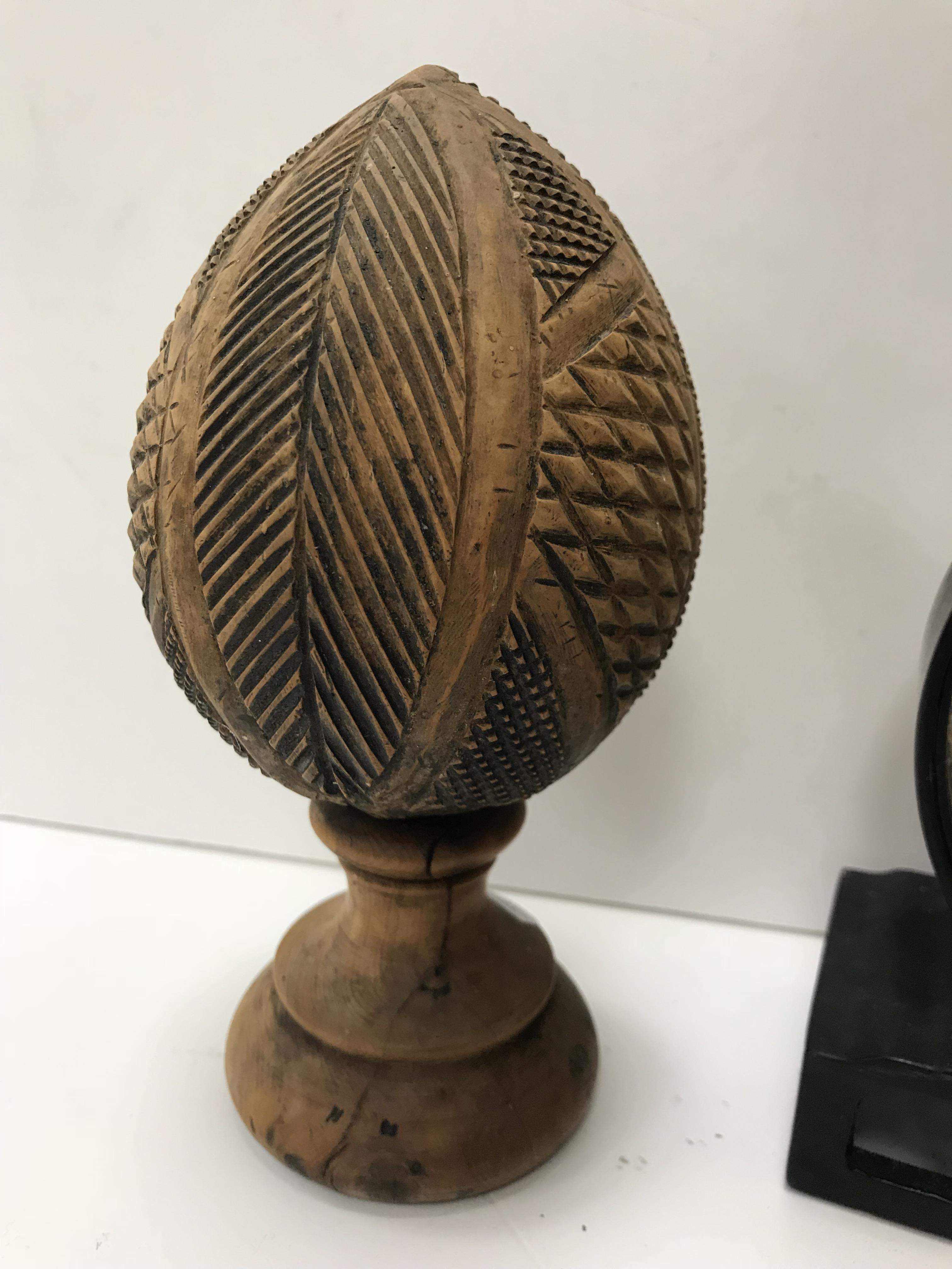 A 19th Century carved coconut with geometric style decoration, raised on a turned wooden base/socle, - Image 3 of 3