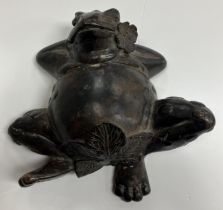 A bronze figure of a frog lying down 16.