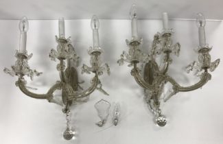 A pair of early 20th Century glass three light wall sconces with simulated candle lamps,