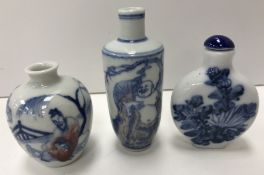 A Chinese blue and white moon flask shaped scent or snuff bottle with floral spray decoration with