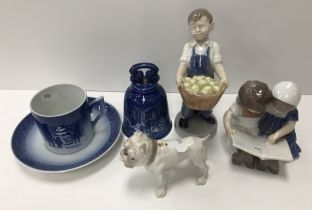 A collection of Royal Copenhagen wares to include a figure of a young boy with basket full of