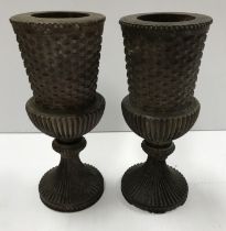 A pair of 19th Century carved rosewood goblets of stylised thistle form raised on a reeded circular