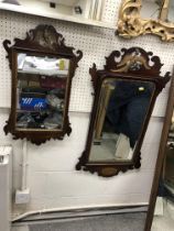 A walnut framed fretwork carved wall mirror in the early 18th Century taste with hoho bird finial