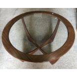 A G Plan walnut framed glass top circular coffee table on shaped X frame base,