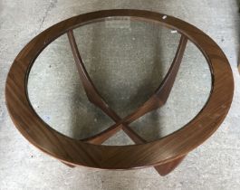 A G Plan walnut framed glass top circular coffee table on shaped X frame base,