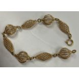 An 18 carat gold filigree style openwork bracelet with globe / lozenge bead decoration, 19.