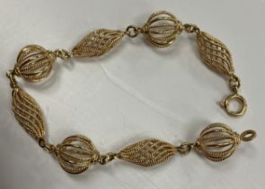 An 18 carat gold filigree style openwork bracelet with globe / lozenge bead decoration, 19.