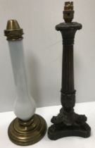 An Empire style bronze column table lamp on anthropomorphic lion's paw supports,