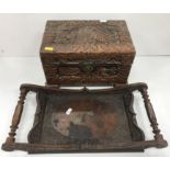 An Indonesian carved camphor wood miniature trunk with all over figural and foliate decoration