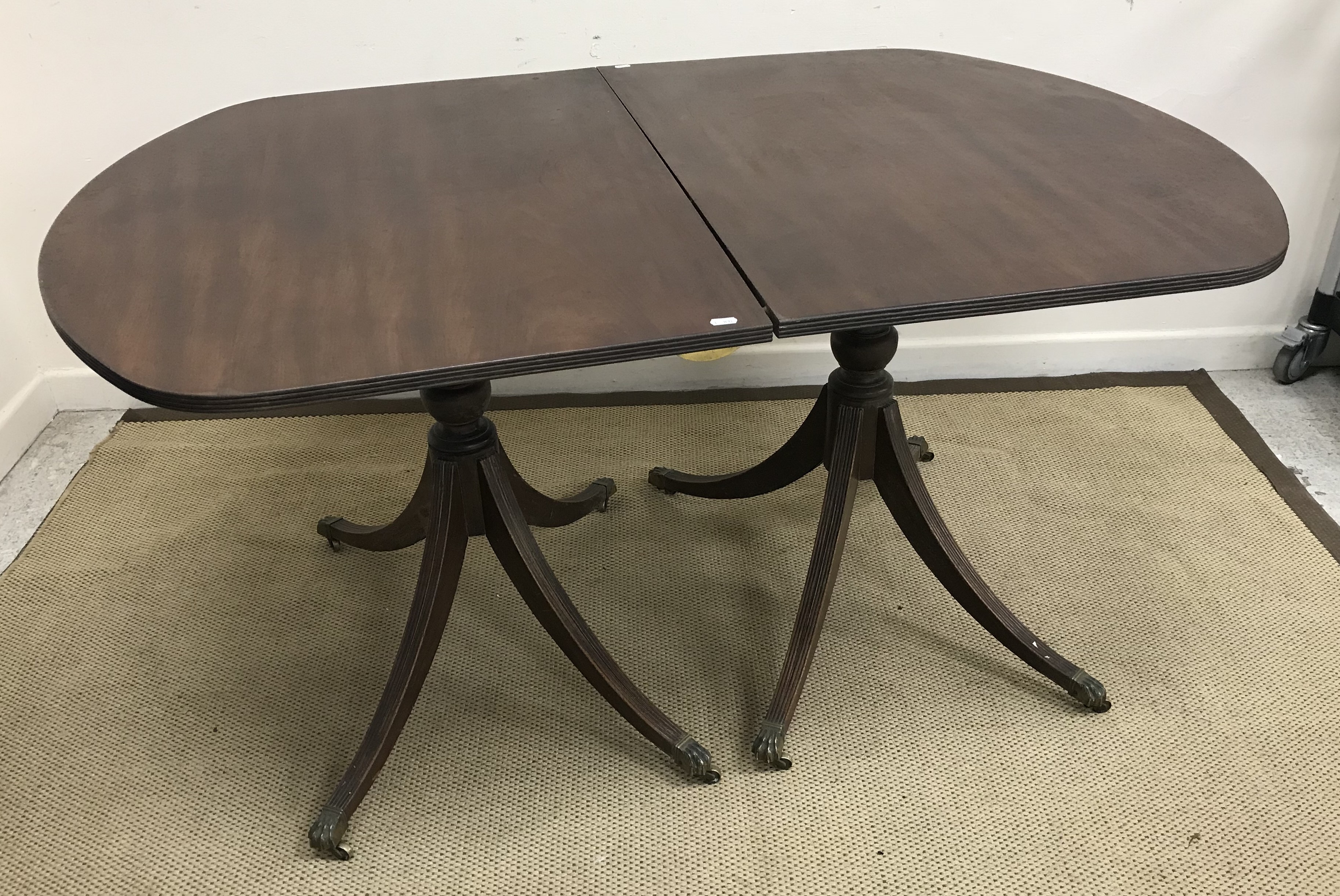 A mahogany D end twin pillar dining table in the George III taste 146 cm long x 97 cm wide x 74 cm