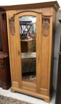 A circa 1900 satin walnut single mirror door wardrobe with carved panels in the Art Nouveau style,