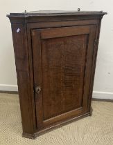A circa 1800 North Country oak and cross-banded hanging corner cupboard,