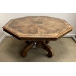 A Victorian walnut veneered breakfast table with octagonal segmented top with feather and