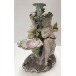 A Meissen style table centre base of two putti, one with squirrrel,