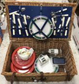 A cane picnic basket with fitted interior