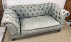 A late Victorian buttoned upholstered Chesterfield scroll arm drop end sofa,