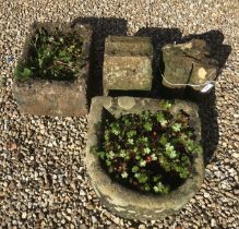 A natural stone D shaped trough,