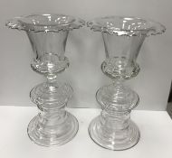 A pair of William Yeoward glass campana shaped urn vases with folded rims on integral plinth bases
