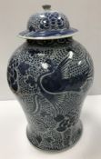 An 18th Century Chinese blue and white baluster shaped vase and cover,