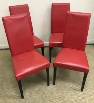 A set of four modern red leather upholstered dining chairs on square tapered black lacquered