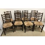 A set of eight oak rush seat ladder back dining chairs in the 17th Century style 46 cm wide x 94 cm