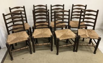 A set of eight oak rush seat ladder back dining chairs in the 17th Century style 46 cm wide x 94 cm