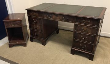 A reproduction mahogany double pedestal kneehole desk with tooled and gilded leather three section