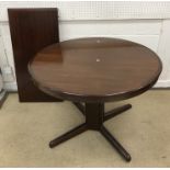 A mid to late 20th Century Danish mahogany circular extending dining table on pedestal quadruped