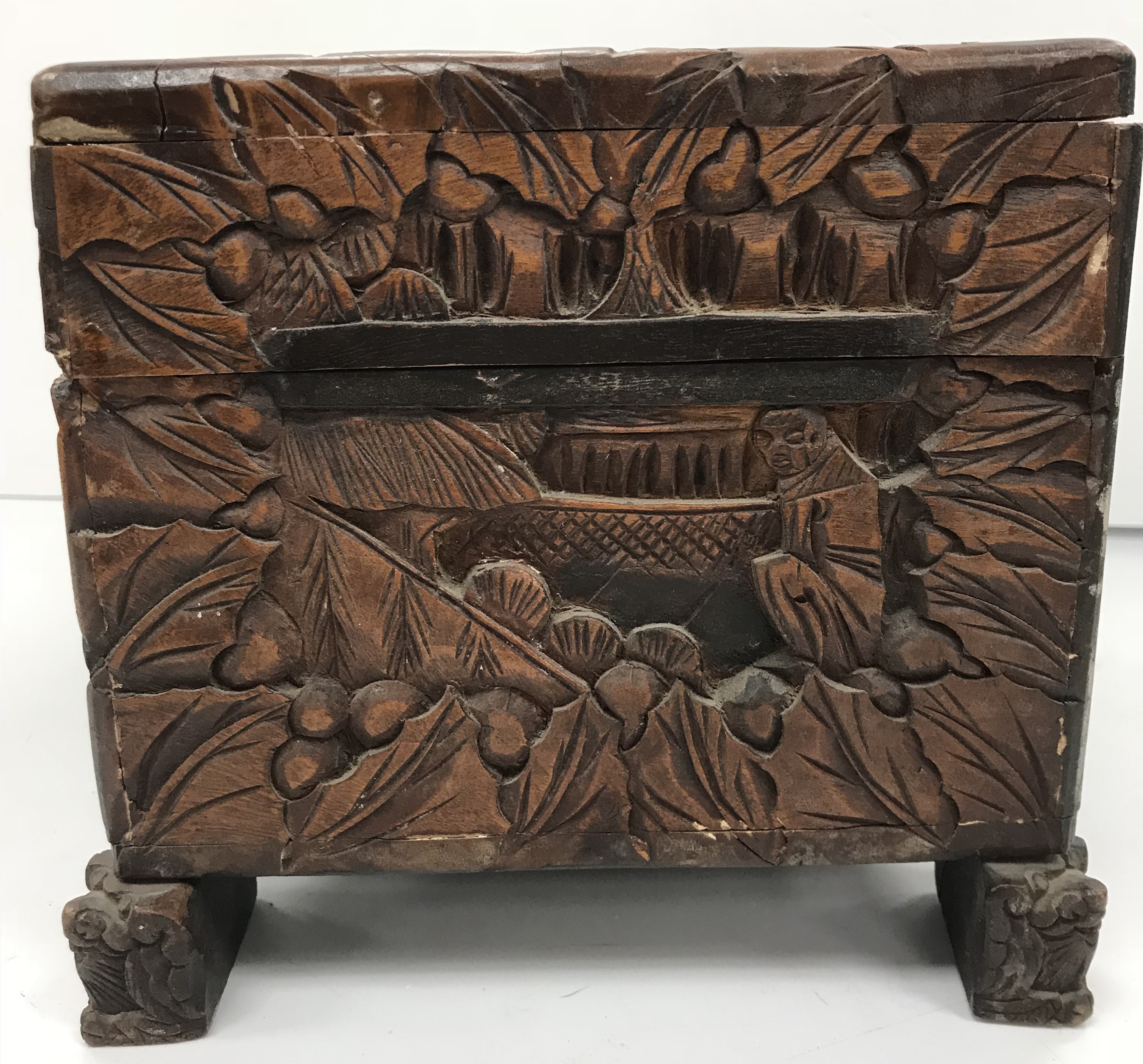 An Indonesian carved camphor wood miniature trunk with all over figural and foliate decoration - Image 6 of 8