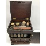 A 19th Century mahogany apothecary box containing various bottles, scales, etc., 23.5 cm wide x 19.