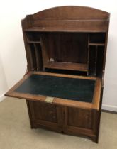 A late Victorian oak student's bureau, the three quarter galleried top over a fall front,