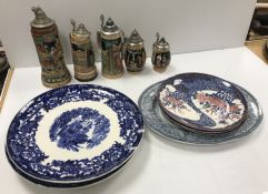 A collection of various serving plates/platters and a collection of Germany steins,