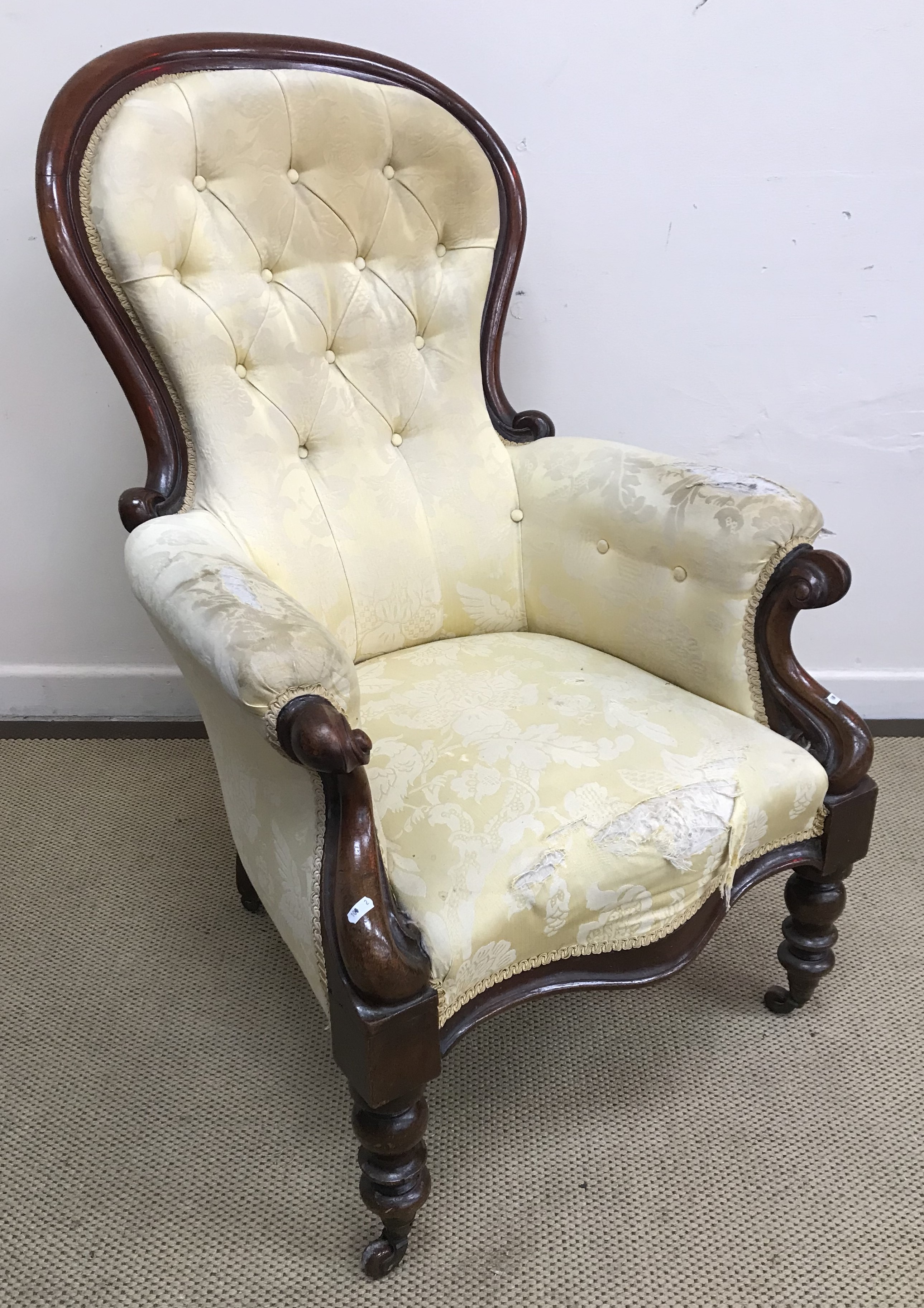 A Victorian show frame, spoon back salon elbow chair with button back and shaped seat,