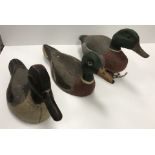 Two vintage painted treenware decoy ducks, one as a mallard drake,