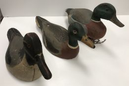 Two vintage painted treenware decoy ducks, one as a mallard drake,