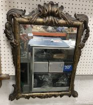 An 18th Century carved giltwood and gesso framed wall mirror with foliate and floral swag