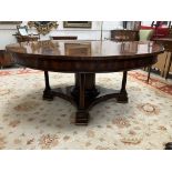 A modern figured mahogany and cross-banded circular extending dining table by Brights of Nettlebed,