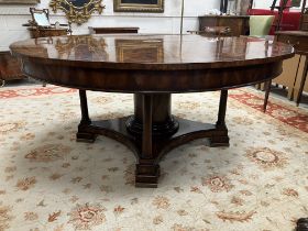 A modern figured mahogany and cross-banded circular extending dining table by Brights of Nettlebed,