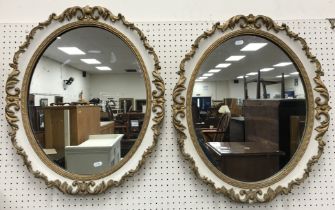 A pair of oval gilt gesso framed and cream painted wall mirrors in the Georgian style 52 cm x 62 cm