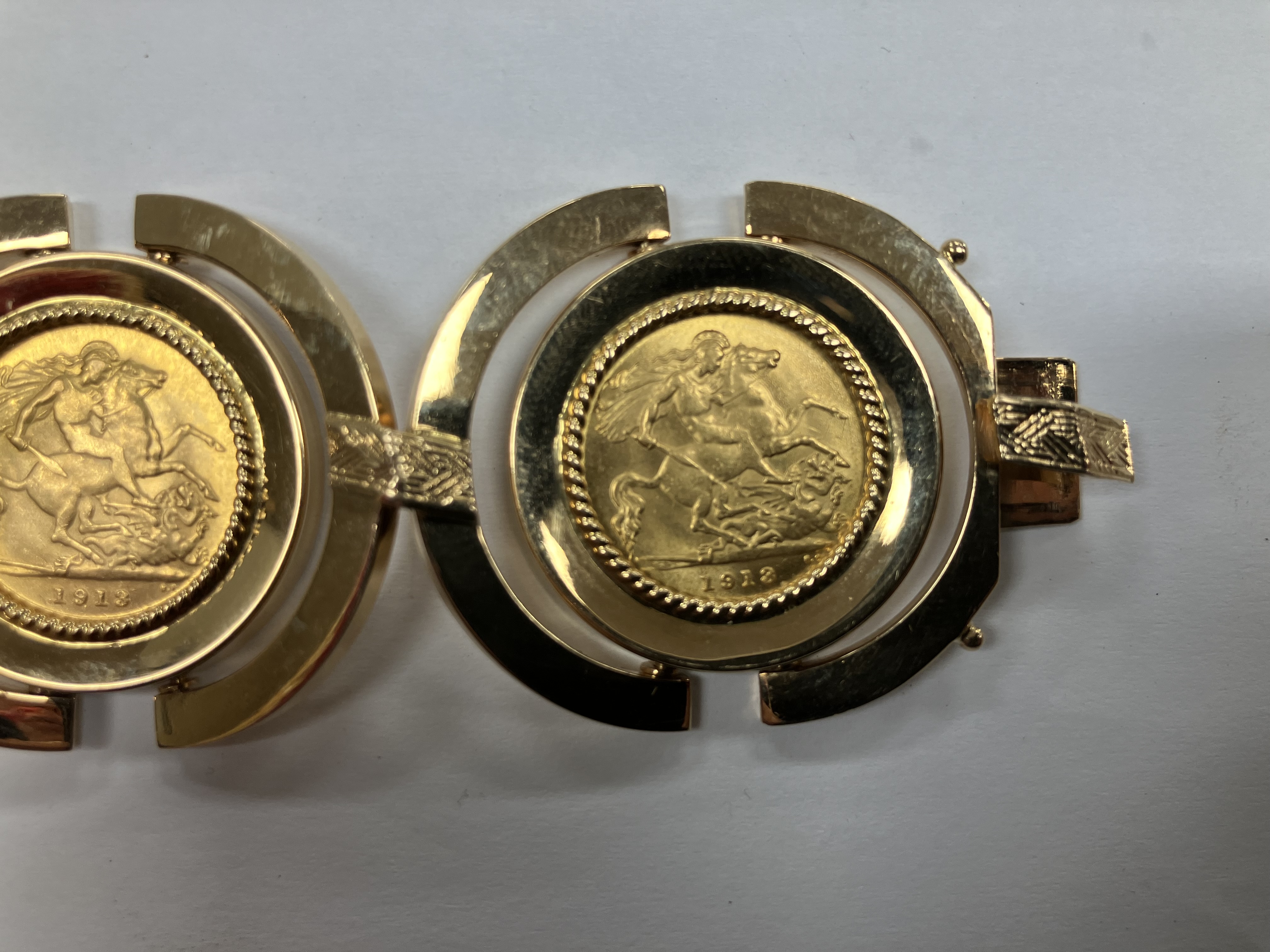 An 18 carat gold bracelet with Arezzo hallmarks, set with five George V gold half sovereigns, 1913, - Image 16 of 16