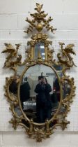 An 18th Century carved giltwood and gesso framed wall mirror in the Chinese Chippendale taste,